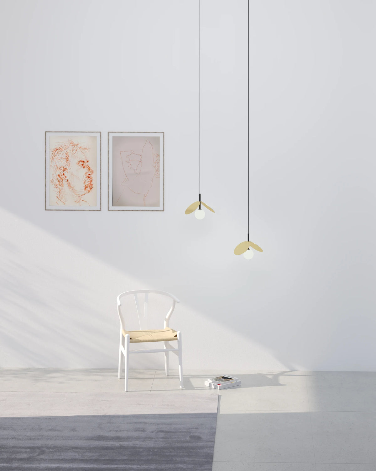 Brass disc globe pendant with fabric cable, black, two pendants in a pale room with framed art