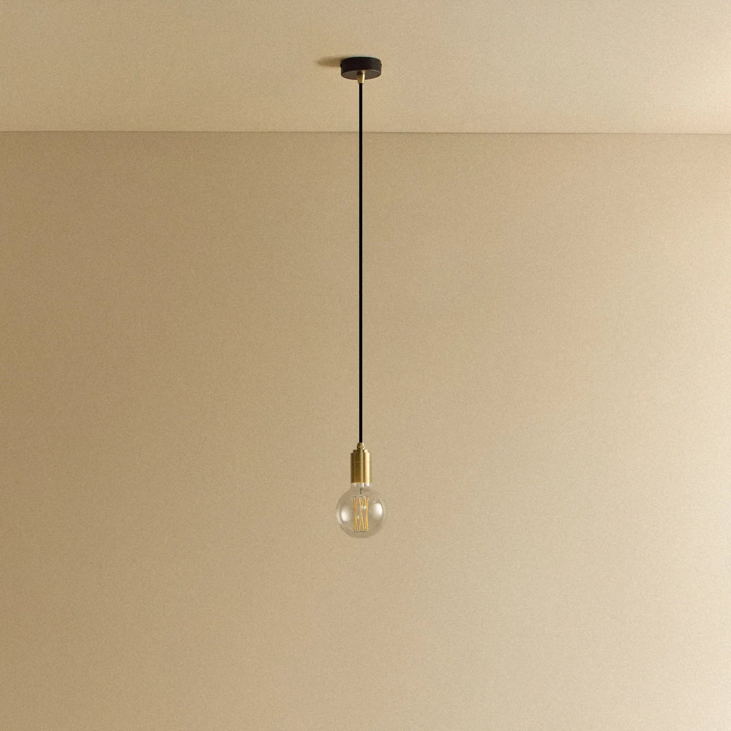 Brass pendant with non-tinted glass filament bulb, unlit