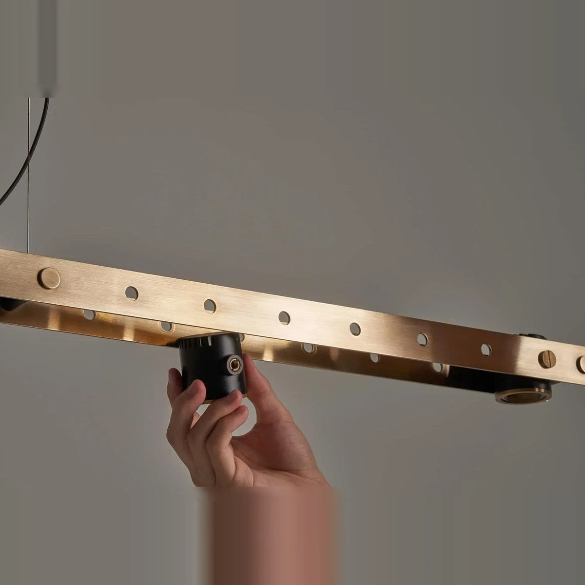 Brass track LED pendant, fitting a spot by hand