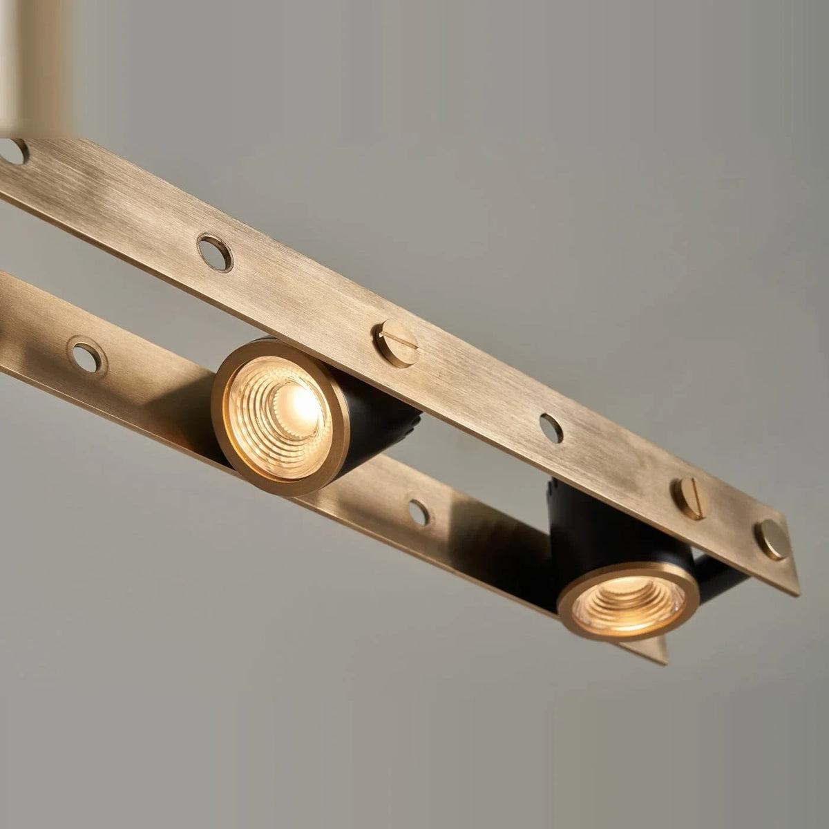 Brass track LED pendant, close-up of two lit spots