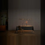 Brass track LED pendant, above a dining table at night