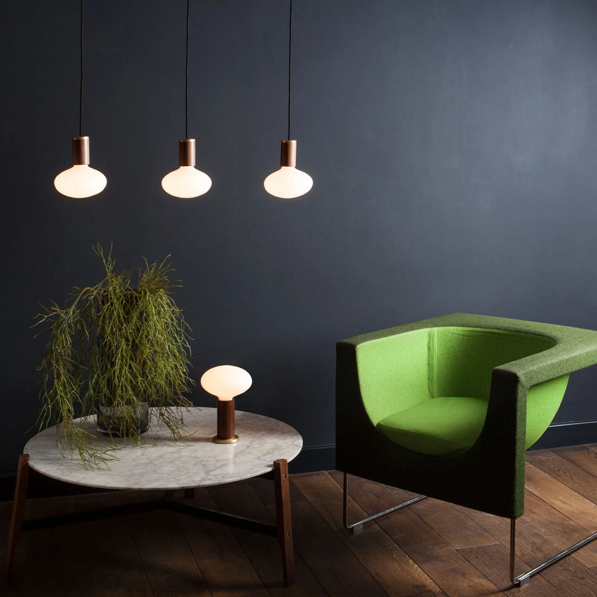 Broad dome matte white glass pendant, graphite, three together above a coffee table