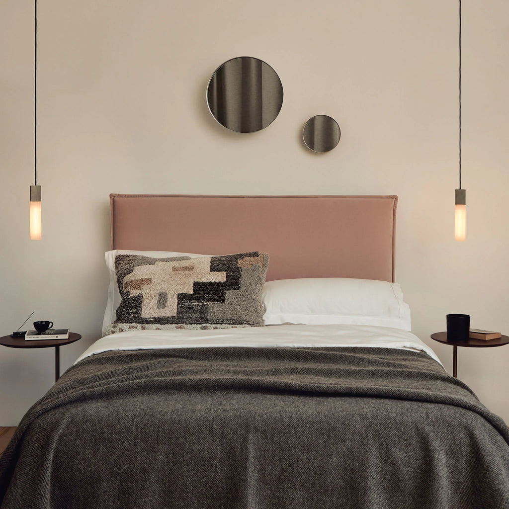 Cast metal hexagonal pendant, a pair beside a bed