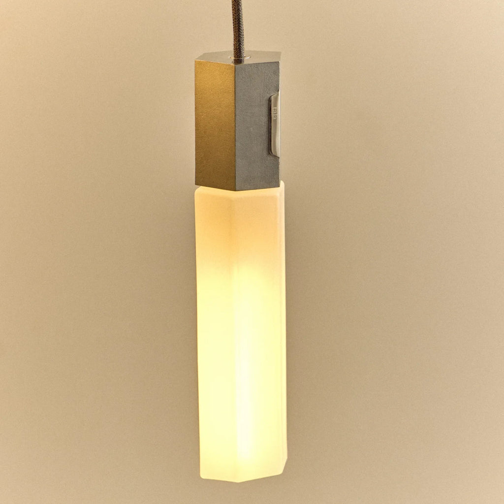 Cast metal hexagonal pendant, close-up, lit