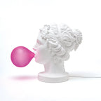 Classical bust table lamp with a pink bubblegum bubble, side view