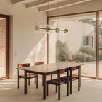 Clear glass disc linear LED pendant, above a dining table