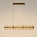 Clear glass disc linear LED pendant, lit, with aged gold canopy