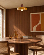 Two-tone disc pendant light, in yellow above a dining table