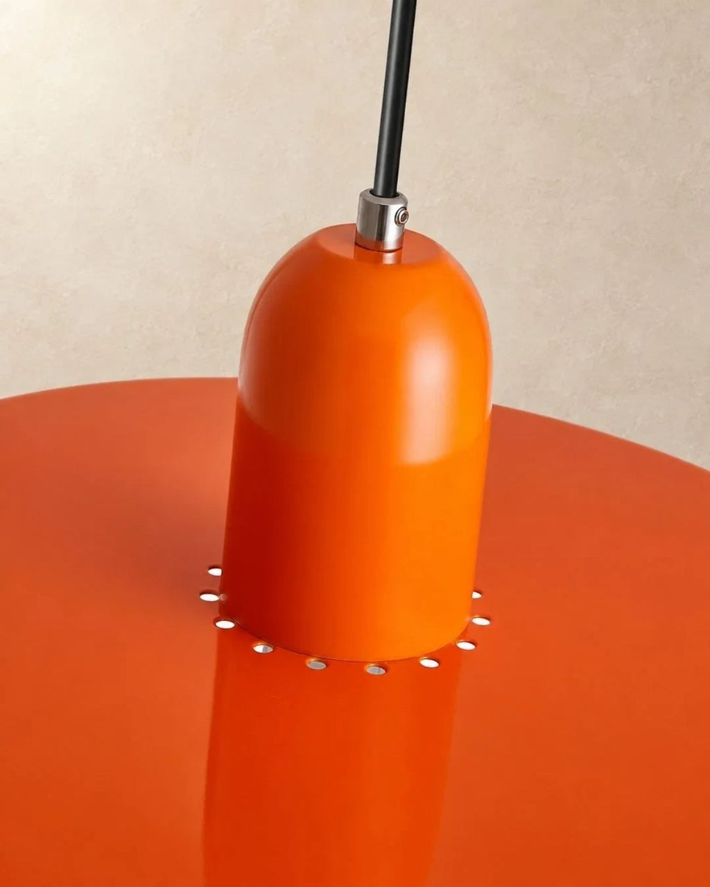 Two-tone disc pendant light, close-up of the orange cap