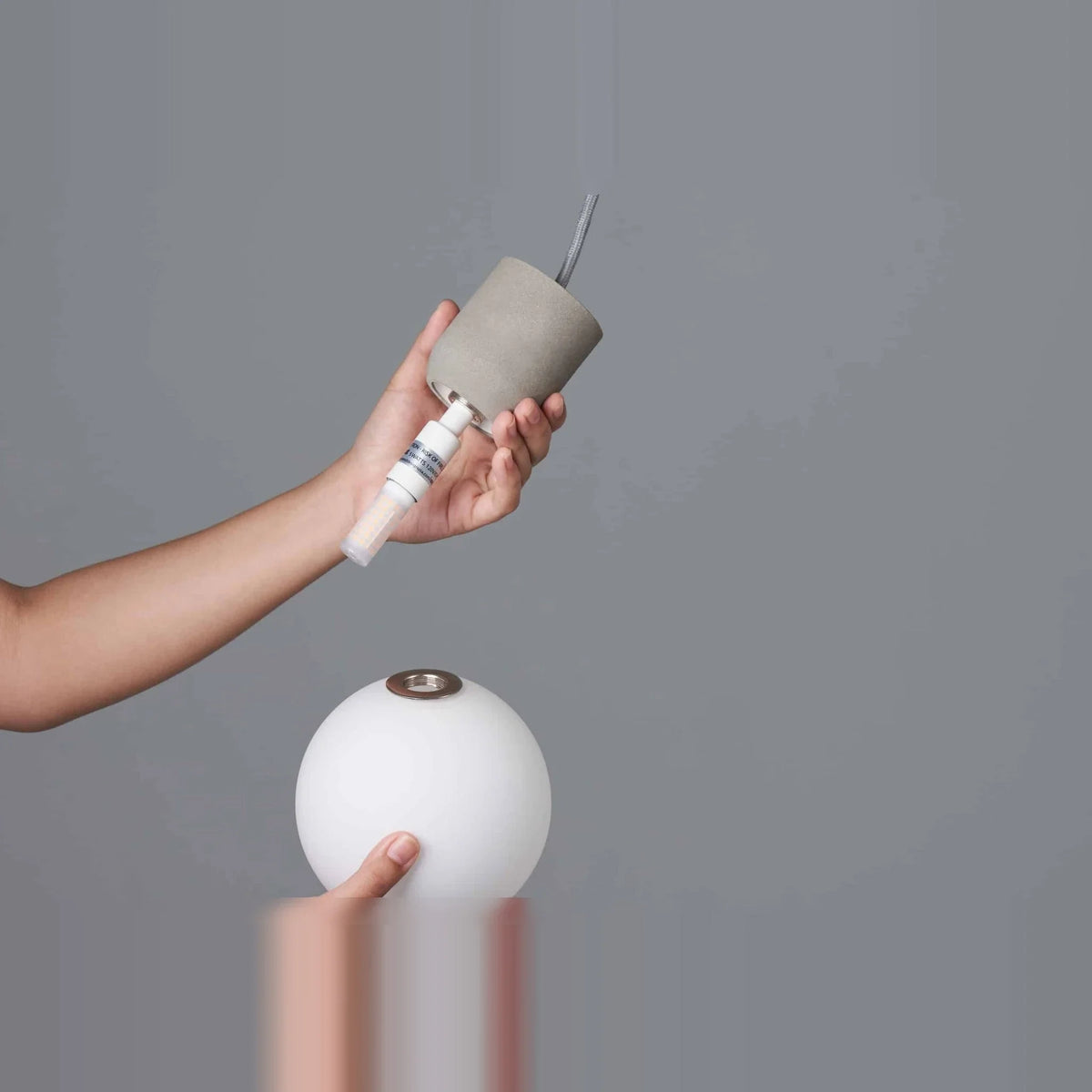 Concrete and glass globe pendant, fitting the bulb