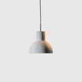 Concrete bell pendant, on a pale background