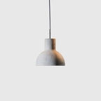 Concrete bell pendant, on a pale background