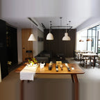 Concrete bell pendant, in a row above a long table