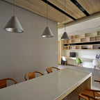 Concrete cone pendant, three in a row above a long table