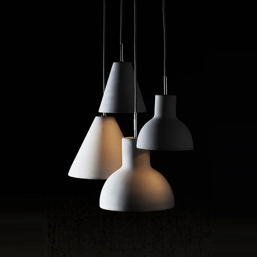 Concrete cone pendant, lit with other concrete shades