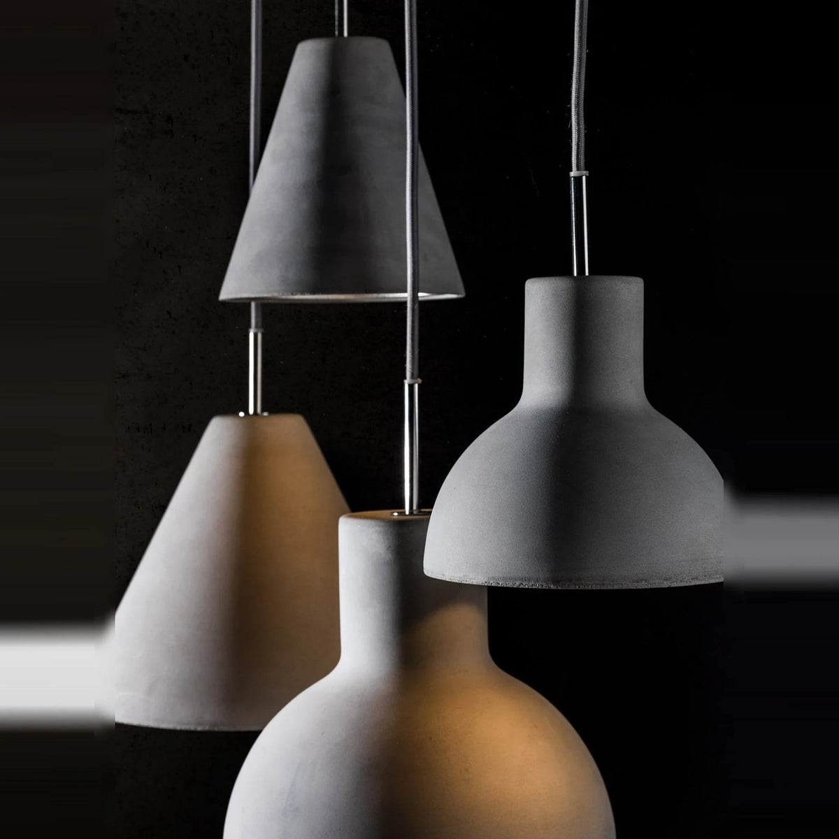 Concrete cone pendant, grouped with other concrete shades