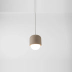 Concrete and opal glass mini pendant, against a white wall