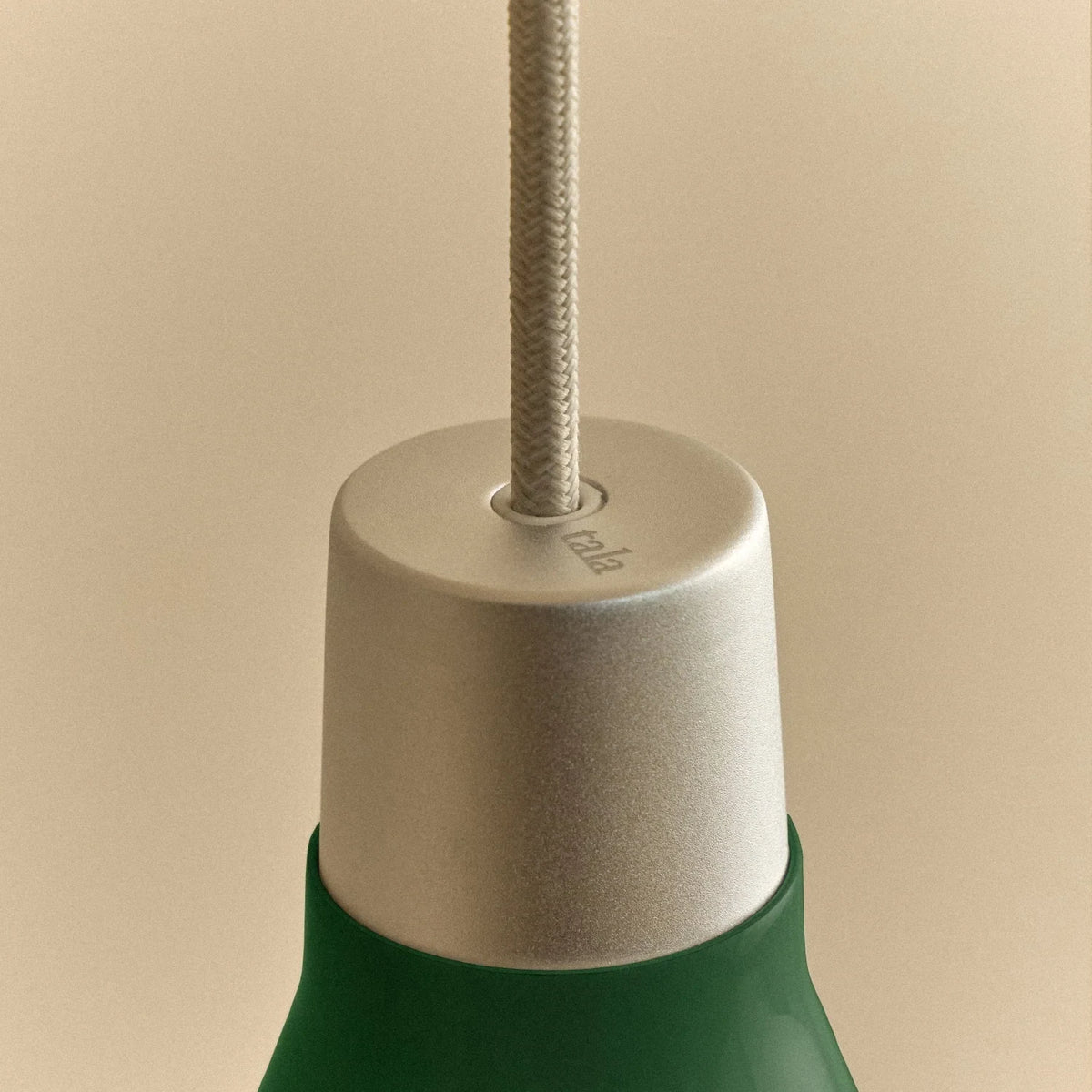 Medium dark green steel pendant with matt white globe bulb, close-up of the holder