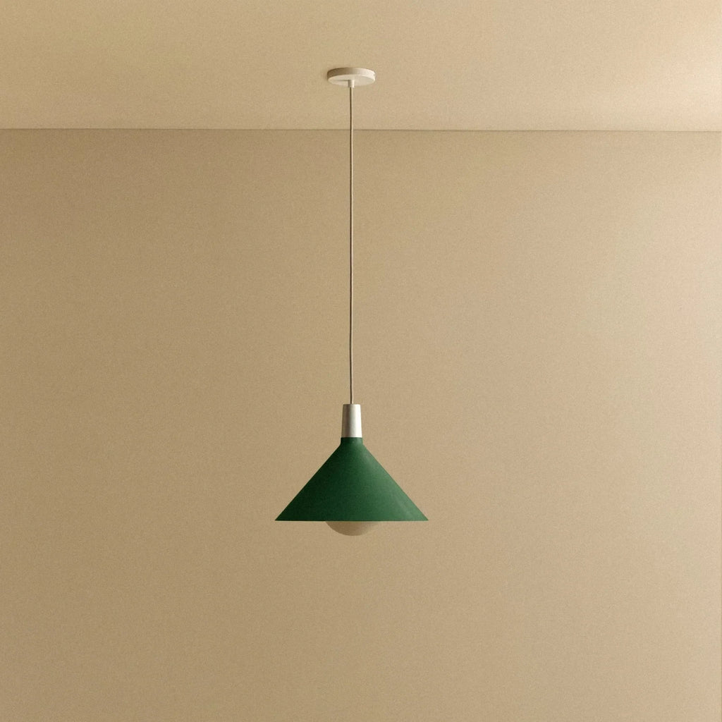 Medium dark green steel pendant with matt white globe bulb, against a plain wall, alternative view