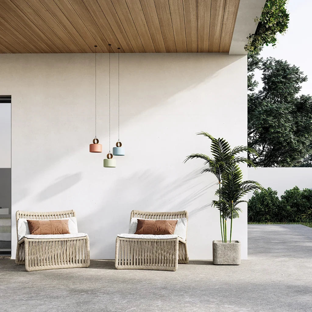 Cordless ceramic drum table lamp with leather ring handle, hanging on a covered terrace