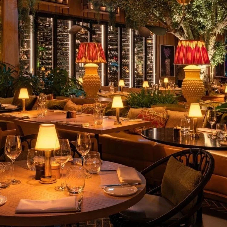 Cordless pleated shade table lamp, lit on a restaurant table