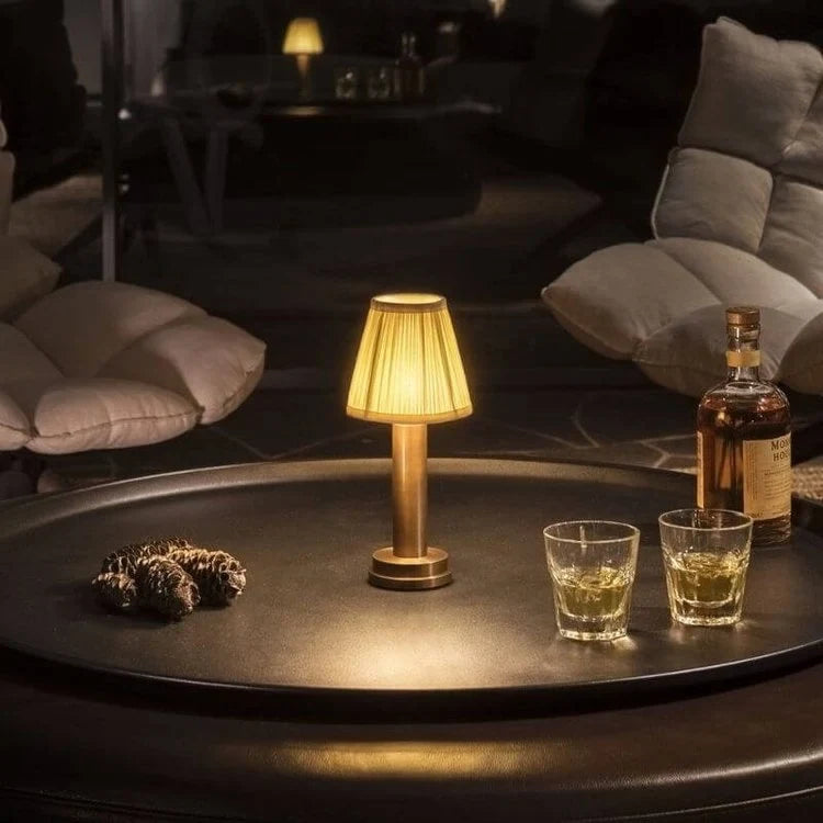 Cordless pleated shade table lamp, lit on a restaurant table