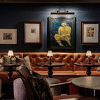 Cordless pleated shade table lamp, lit on a restaurant table