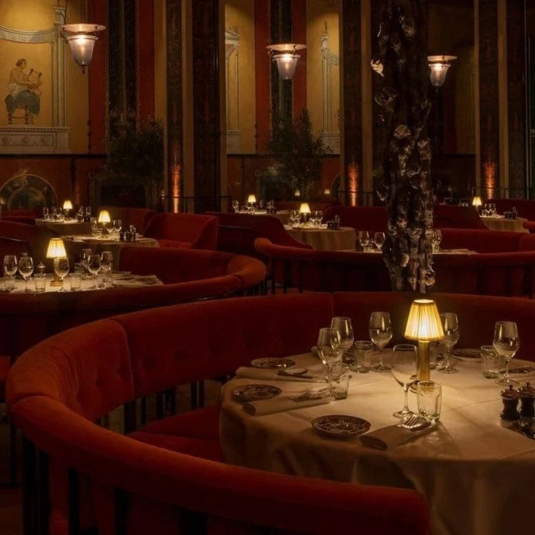 Cordless pleated shade table lamp, lit on a restaurant table