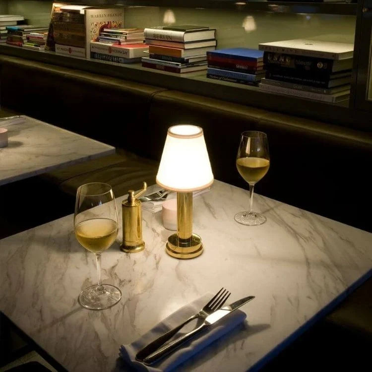 Cordless pleated shade table lamp, lit on a restaurant table