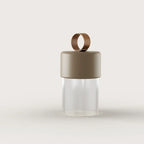 Cordless fluted glass table lamp, with a taupe ceramic cap, front view