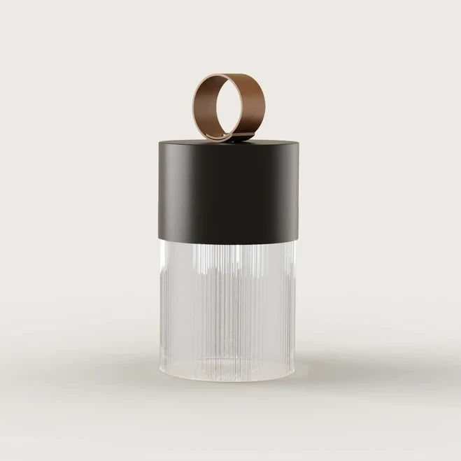 Cordless fluted glass table lamp, with a matte black metal lid, front view