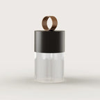 Cordless fluted glass table lamp, with a matte black metal lid, front view