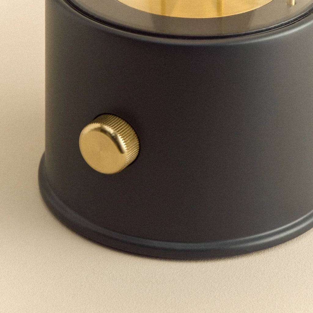 Cordless lantern lamp, black finish, close-up of the brass control knob