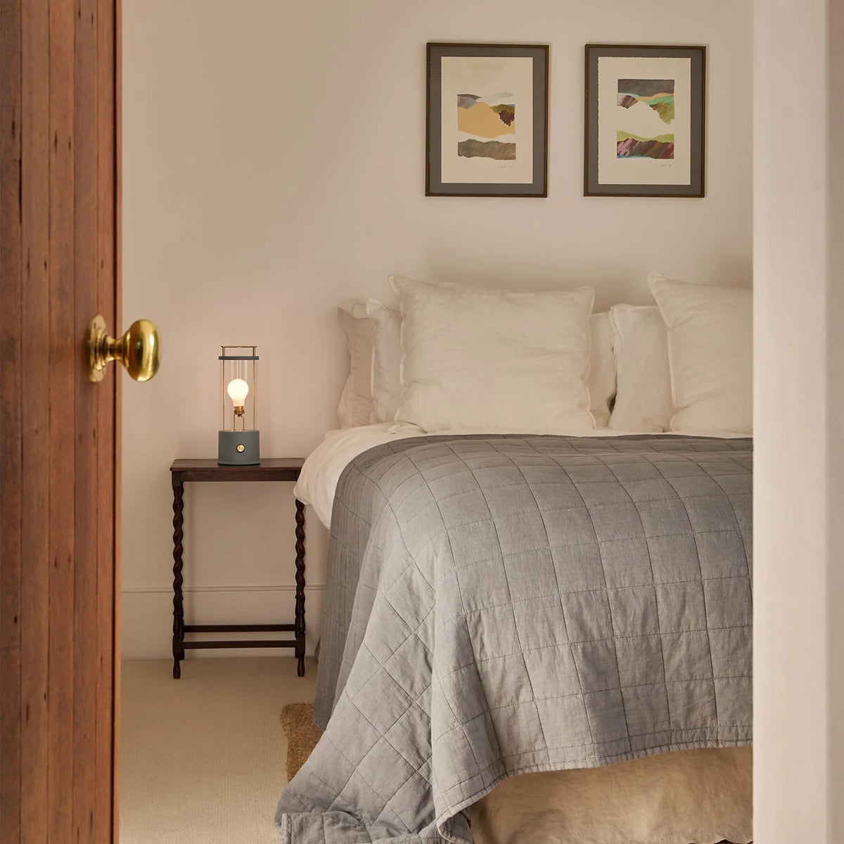 Cordless lantern lamp, blue finish, beside a bed
