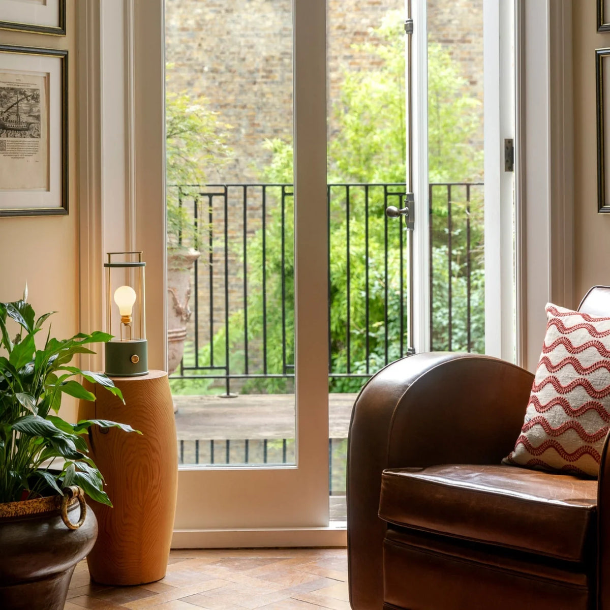 Cordless lantern lamp, green finish, on a side table by the balcony door