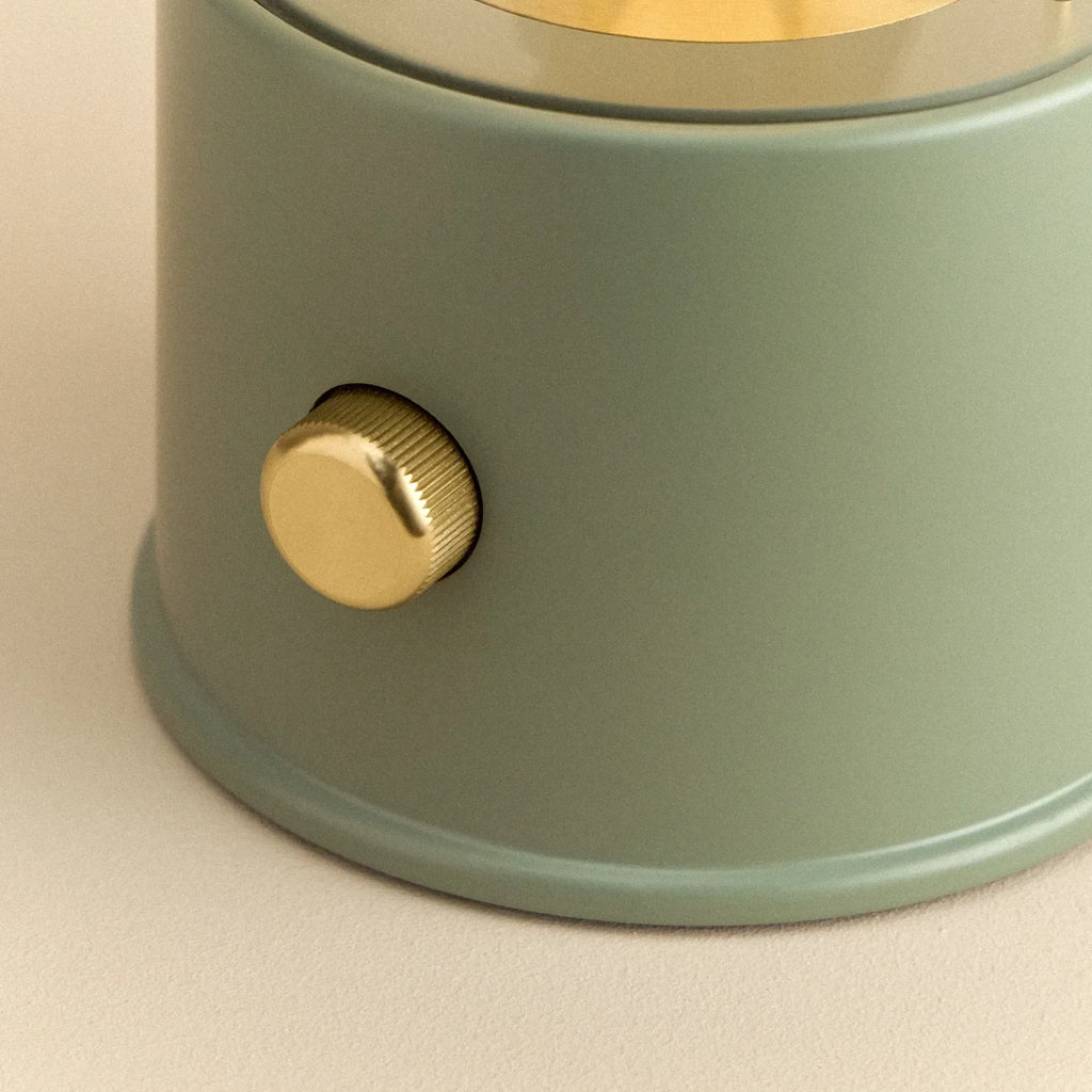 Cordless lantern lamp, green finish, close-up of the brass control knob