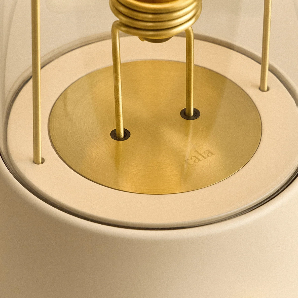 Cordless lantern lamp, plaster pink finish, close-up of the bulb holder and brass plate