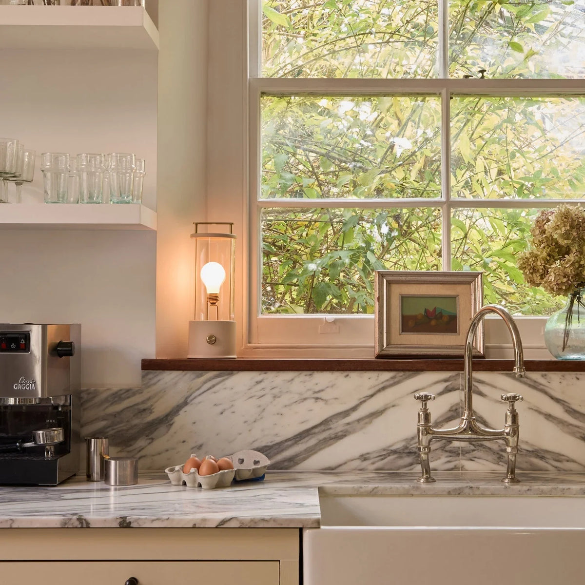 Cordless lantern lamp, plaster pink finish, on a kitchen windowsill