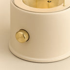 Cordless lantern lamp, plaster pink finish, close-up of the brass control knob