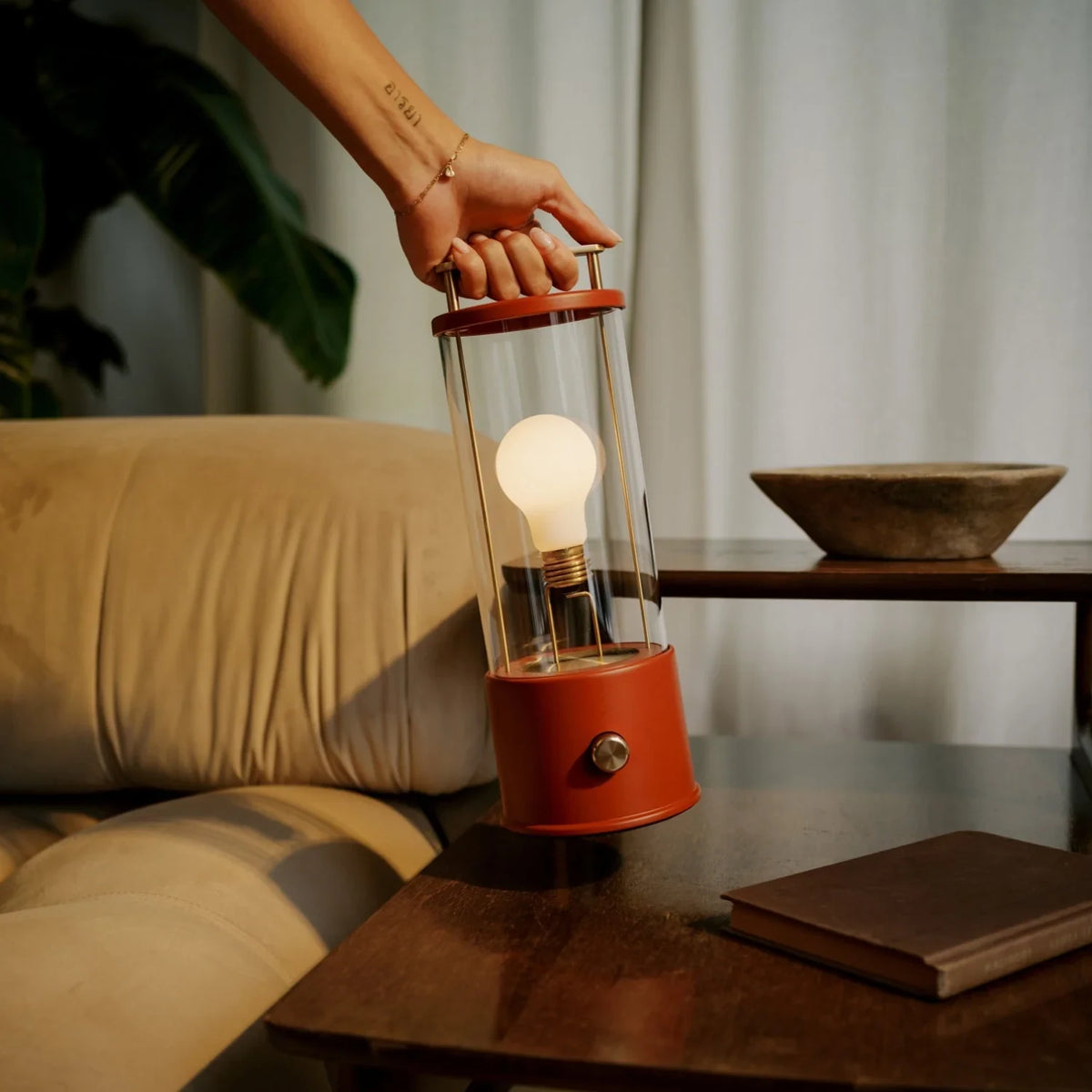 Cordless lantern lamp, red finish, lifted from a side table