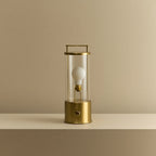 Cordless lantern lamp, solid brass, unlit, on a plain ledge