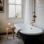 Cordless lantern lamp, solid brass, on a stool beside the bath