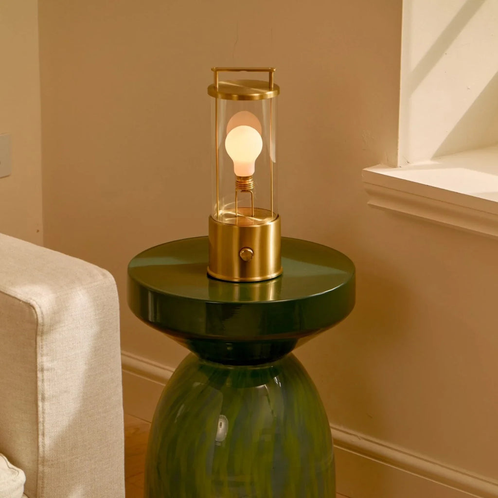 Cordless lantern lamp, solid brass, on a green side table