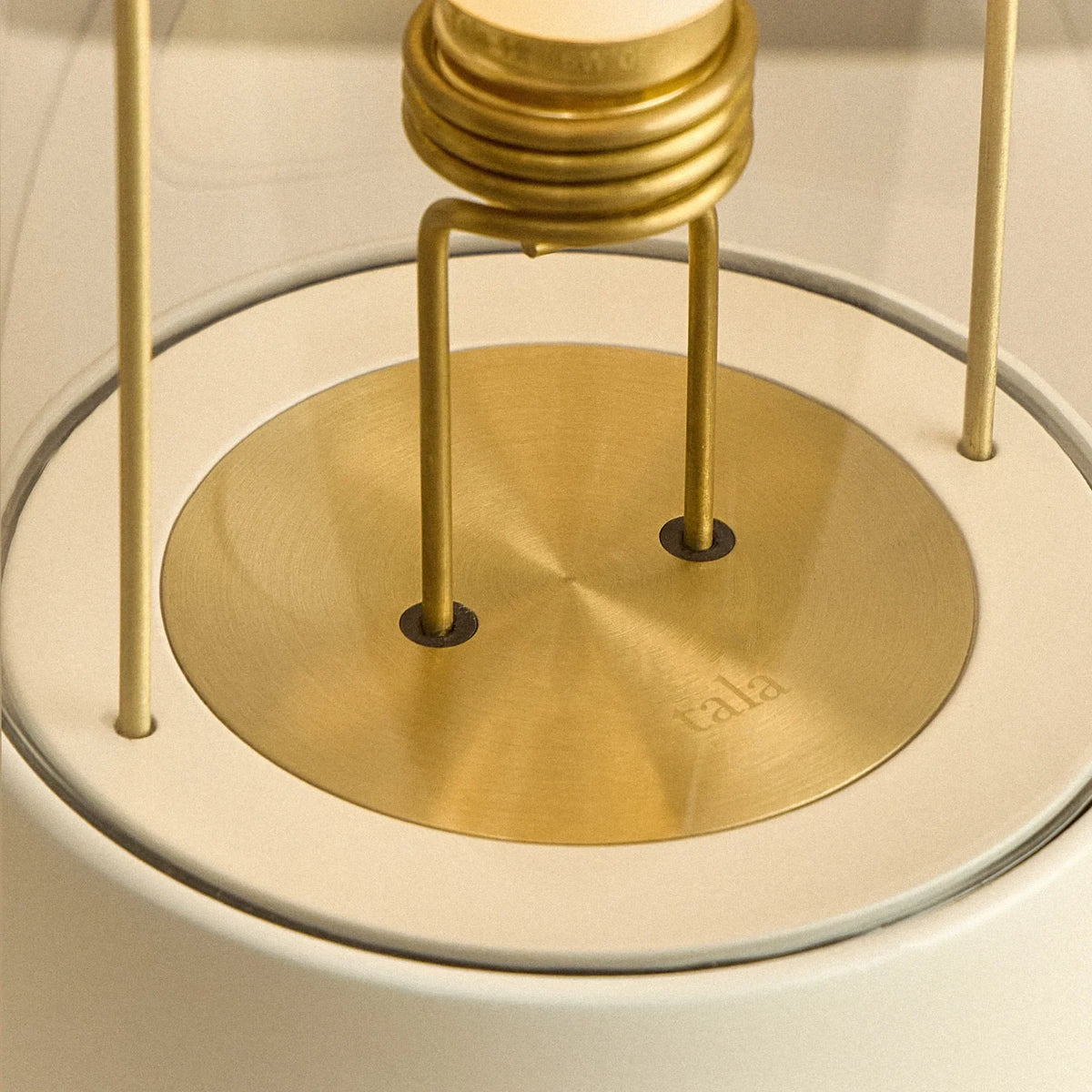Cordless lantern lamp, white finish, close-up of the bulb holder and brass plate