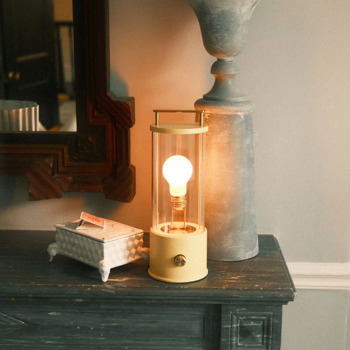 Cordless lantern lamp, yellow finish, on a mantelpiece