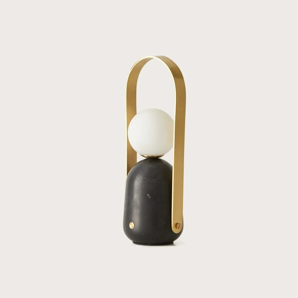 Cordless marble opal globe table lamp, with a brass handle, front view