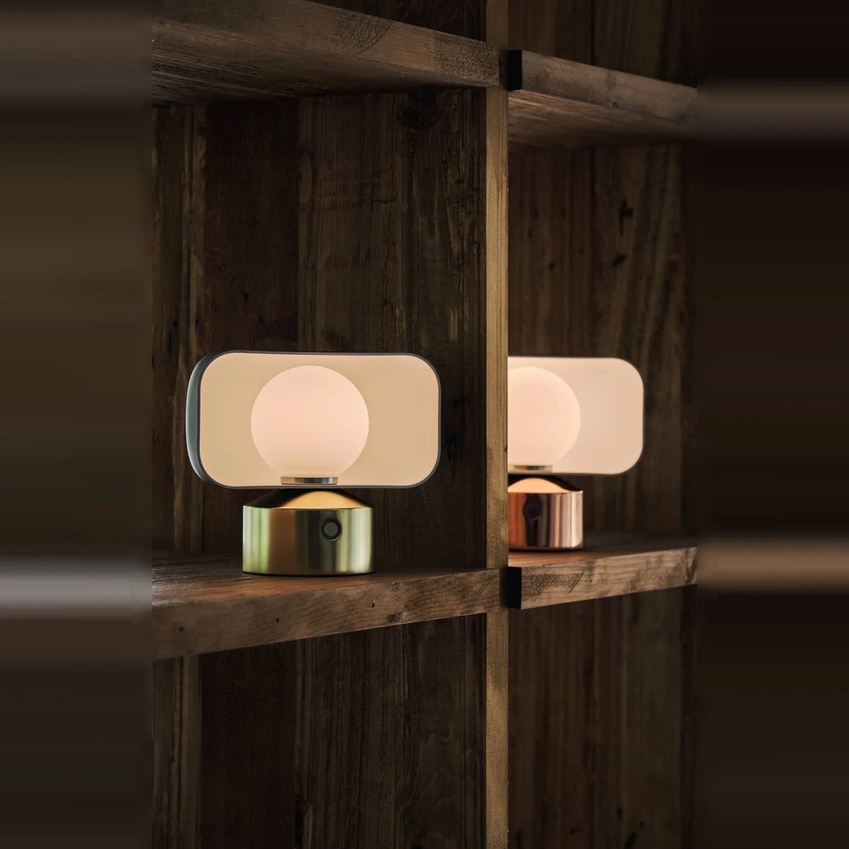 Cordless opal glass table lamp with rotating shade, on a wooden shelf