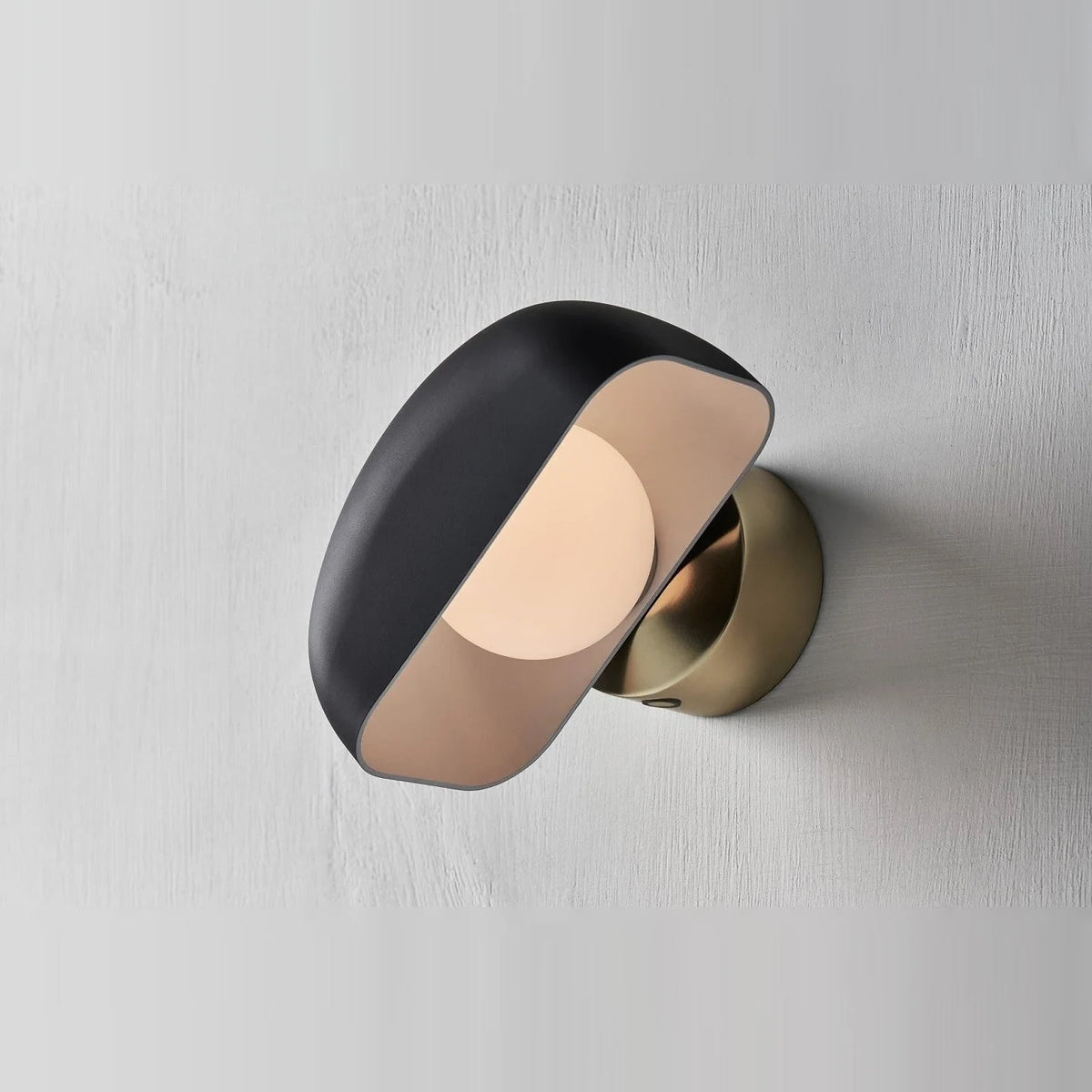Cordless opal glass table lamp with rotating shade, mounted on a wall, close-up