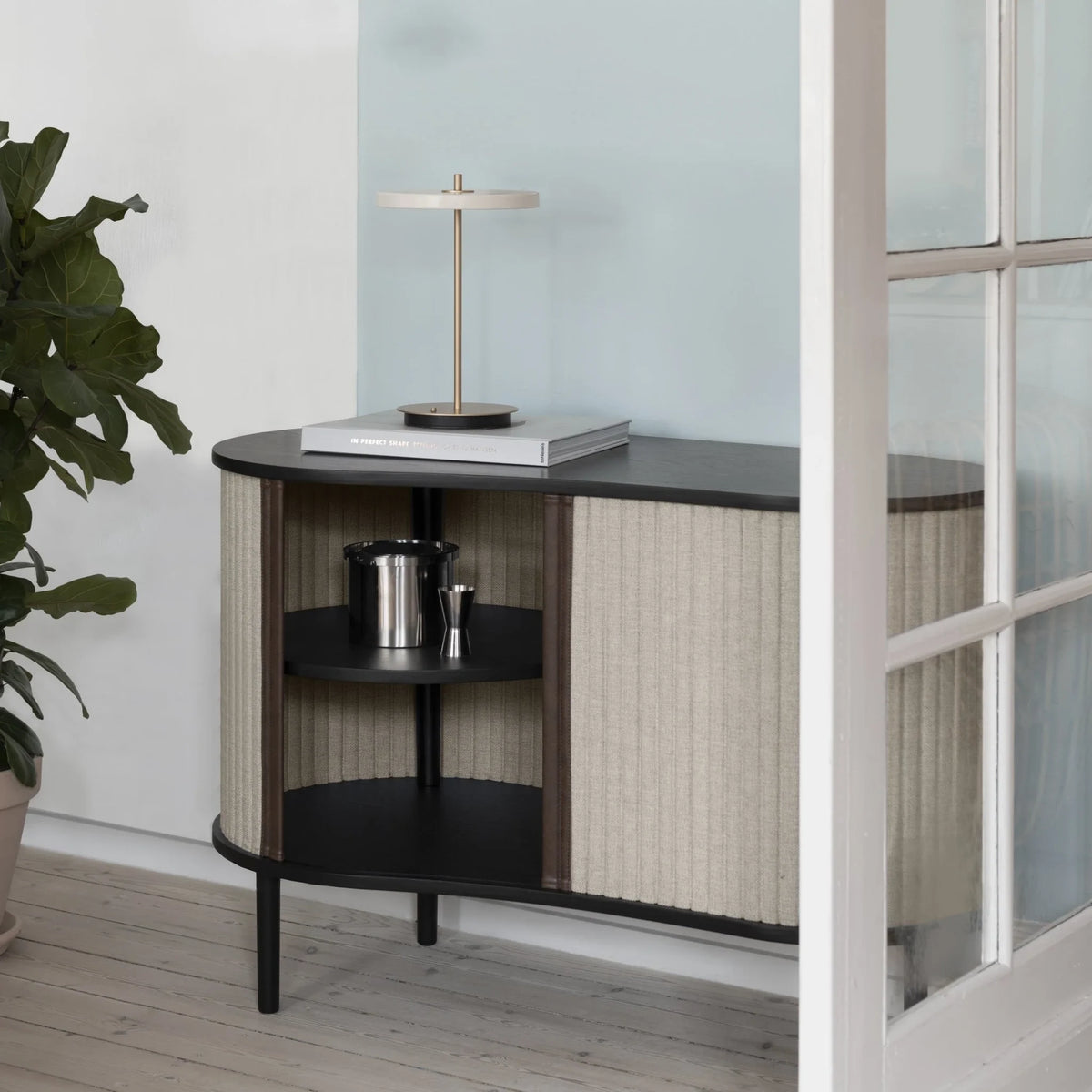 Cordless rechargeable LED table lamp, brass base, in use at home