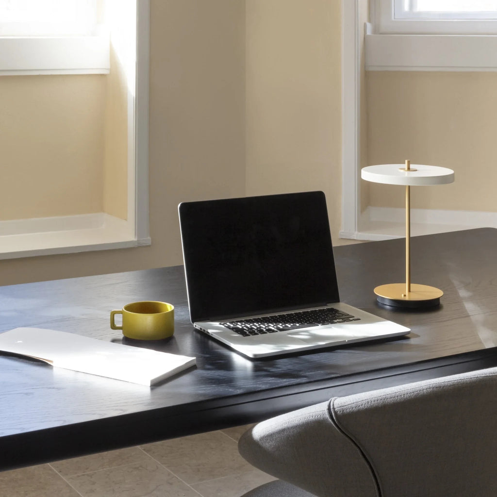Cordless rechargeable LED table lamp, brass base, in use at home